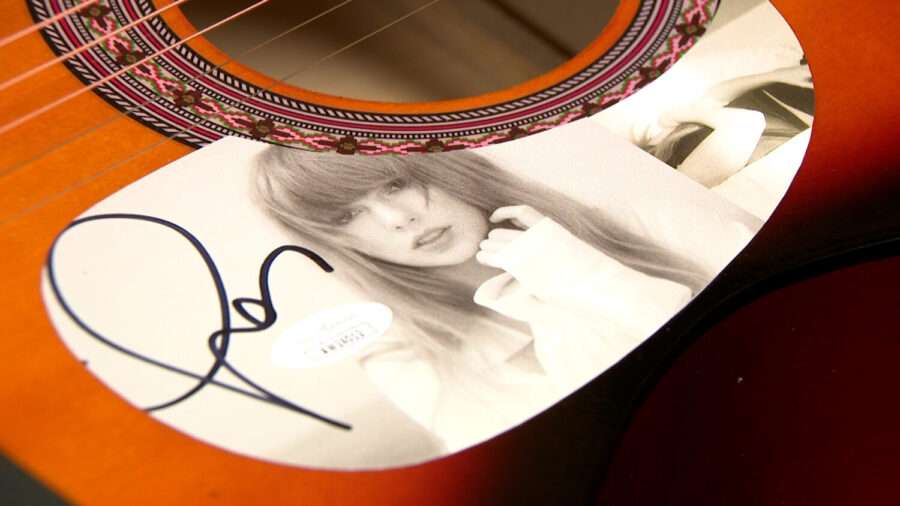 Guitars signed by Taylor Swift, Ariana Grande, and Jon Bon Jovi.