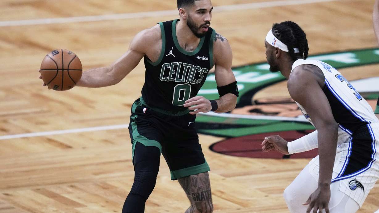 Boston Celtics forward Jayson Tatum (0) drives to the basket against Orlando Magic center Wendell Carter Jr. (34) during the first half in Game 5 of a first-round NBA playoff basketball series, Tuesday, April 29, 2025, in Boston.