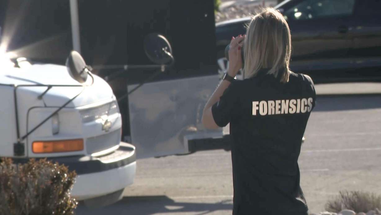 A crime scene investigator takes photos of the scene at 2600 North and 900 West in Pleasant Grove, where a 9-year-old boy was hit and killed by a truck on Tuesday. The driver left the scene but was taken into police custody hours later.
