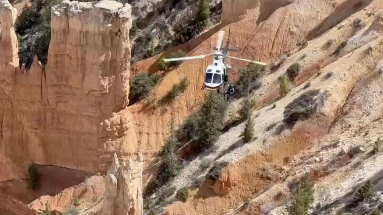 Utah Department of Public Safety's helicopter works to recover two bodies at Bryce Canyon National Park on Tuesday. Investigators with the Garfield County Sheriff's Office say the man and woman apparently fell off a cliff.