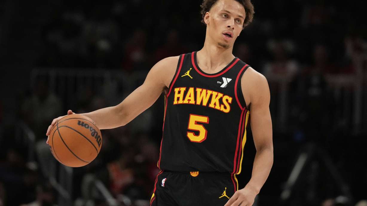 Atlanta Hawks guard Dyson Daniels (5) dribbles in the first half of an NBA play-in tournament basketball game against the Miami Heat, Friday, April 18, 2025, in Atlanta.