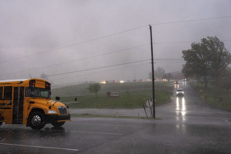 People leave the school as a storm begins at Fort Cherry High School in McDonald, Pa., Tuesday.