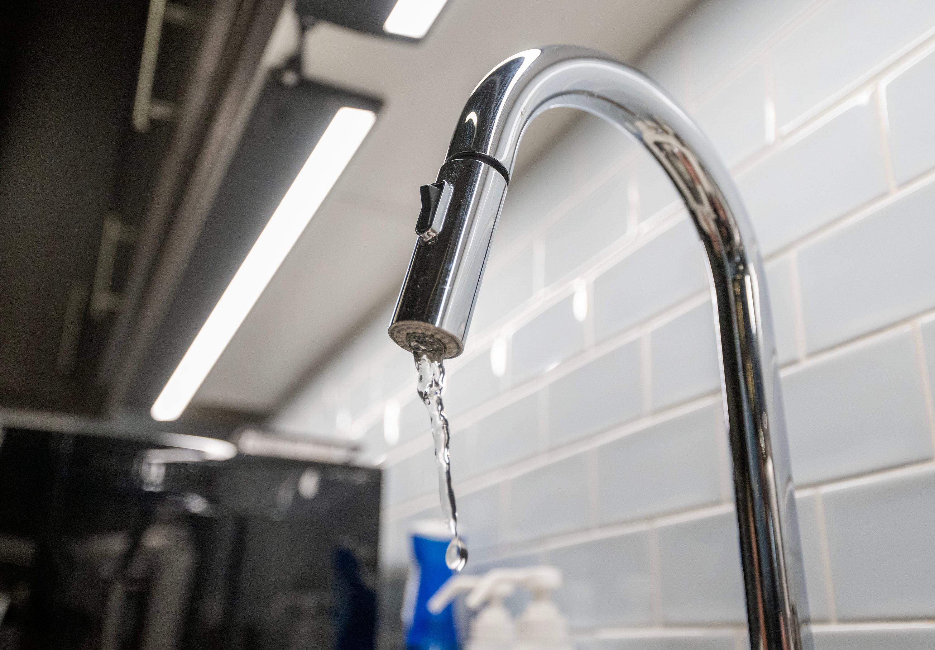 Water runs through a faucet in Salt Lake City on March 31. Questions continue to swirl around adding fluoride to water, which may not all be healthy. Meanwhile, some communities are dropping fluoridated water while others continue to add it.