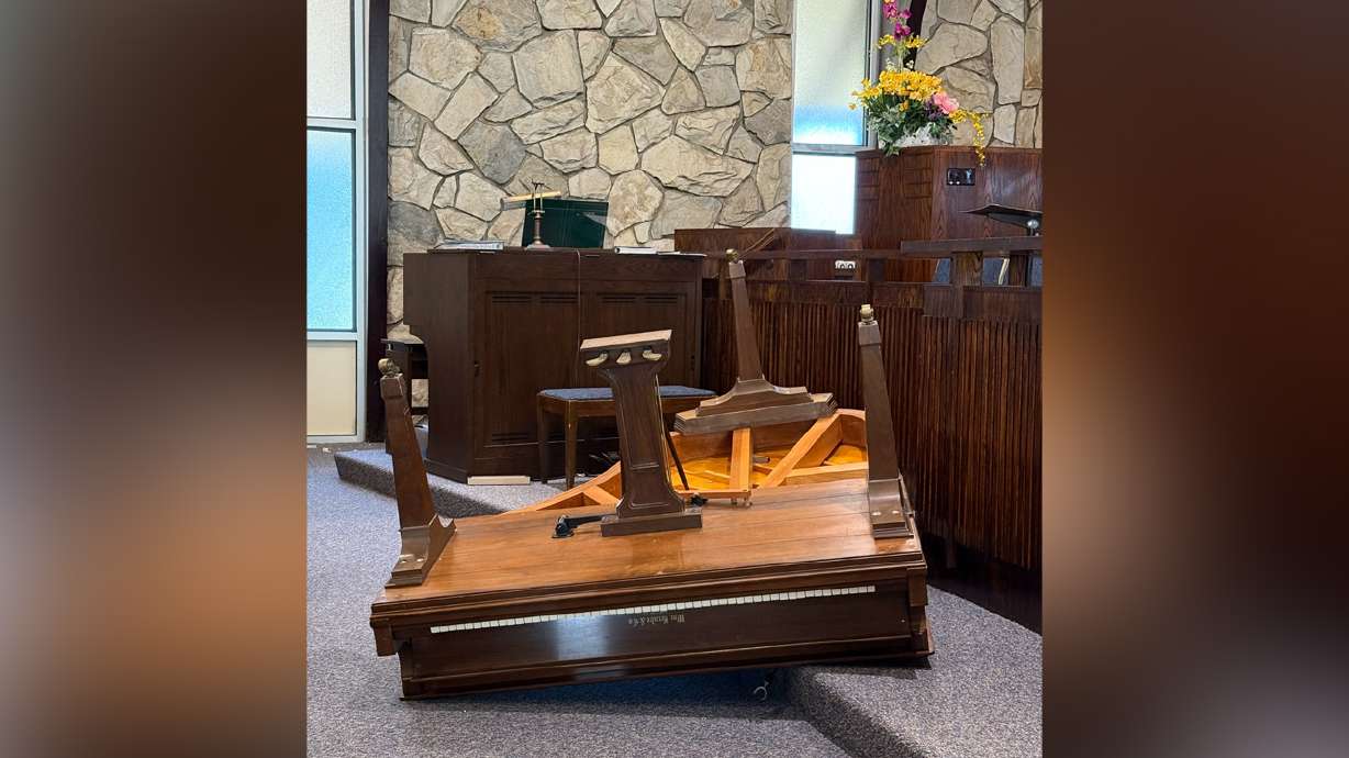 An overturned piano lies awkwardly near the front of the chapel at a Latter-day Saint meetinghouse in Provo after police say someone broke in and vandalized the building.