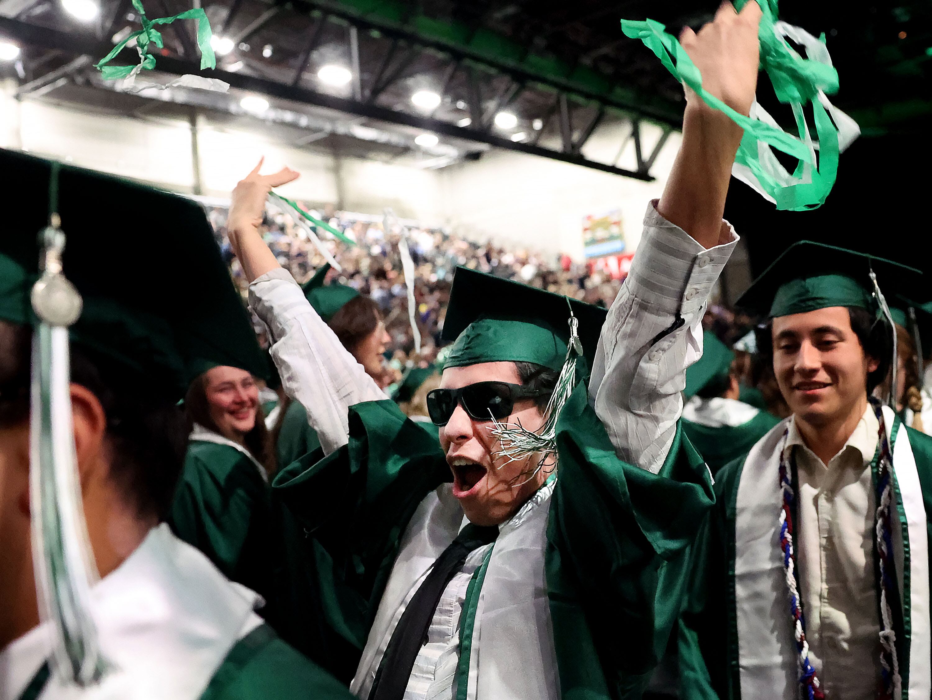Yvan Brensan cheers as he exits the 2025 commencement ceremony in the UCCU Center at Utah Valley University in Orem on Wednesday.