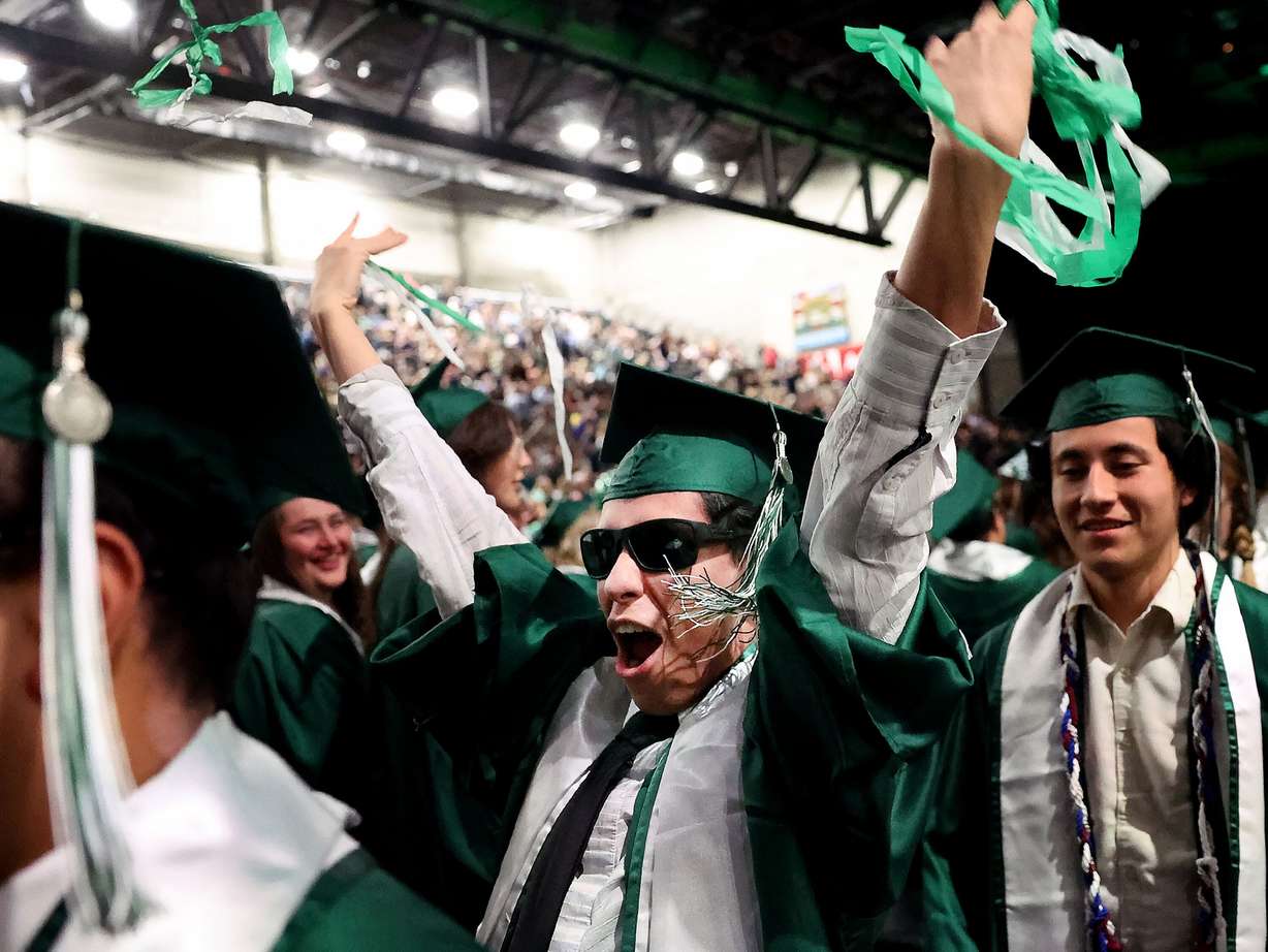 Yvan Brensan cheers as he exits the 2025 commencement ceremony in the UCCU Center at Utah Valley University in Orem on Wednesday.