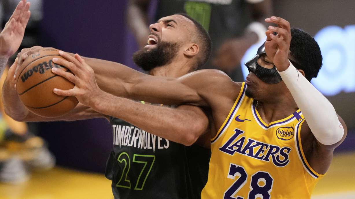 Minnesota Timberwolves center Rudy Gobert, left grabs a rebound next to Los Angeles Lakers forward Rui Hachimura (28) during the first half in Game 5 of an NBA basketball first-round playoff series Wednesday, April 30, 2025, in Los Angeles.