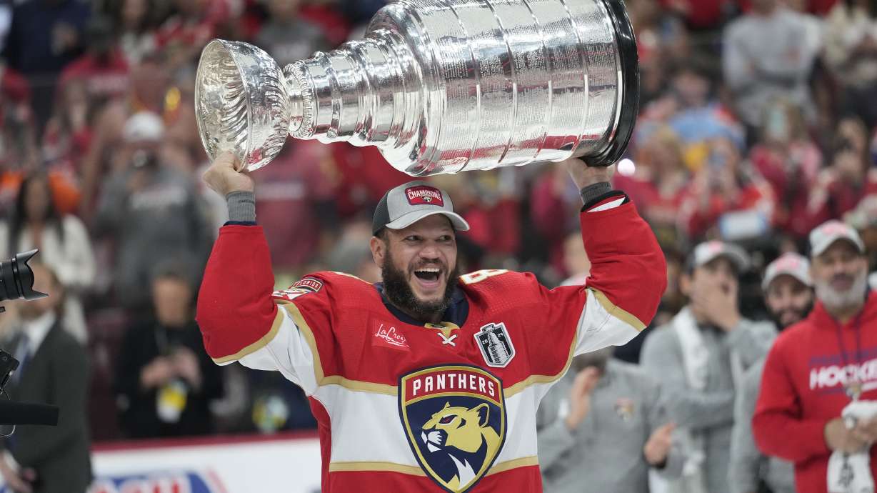 FILE - Florida Panthers right wing Kyle Okposo raises the NHL hockey Stanley Cup trophy after defeating the Edmonton Oilers, June 24, 2024, in Sunrise, Fla.