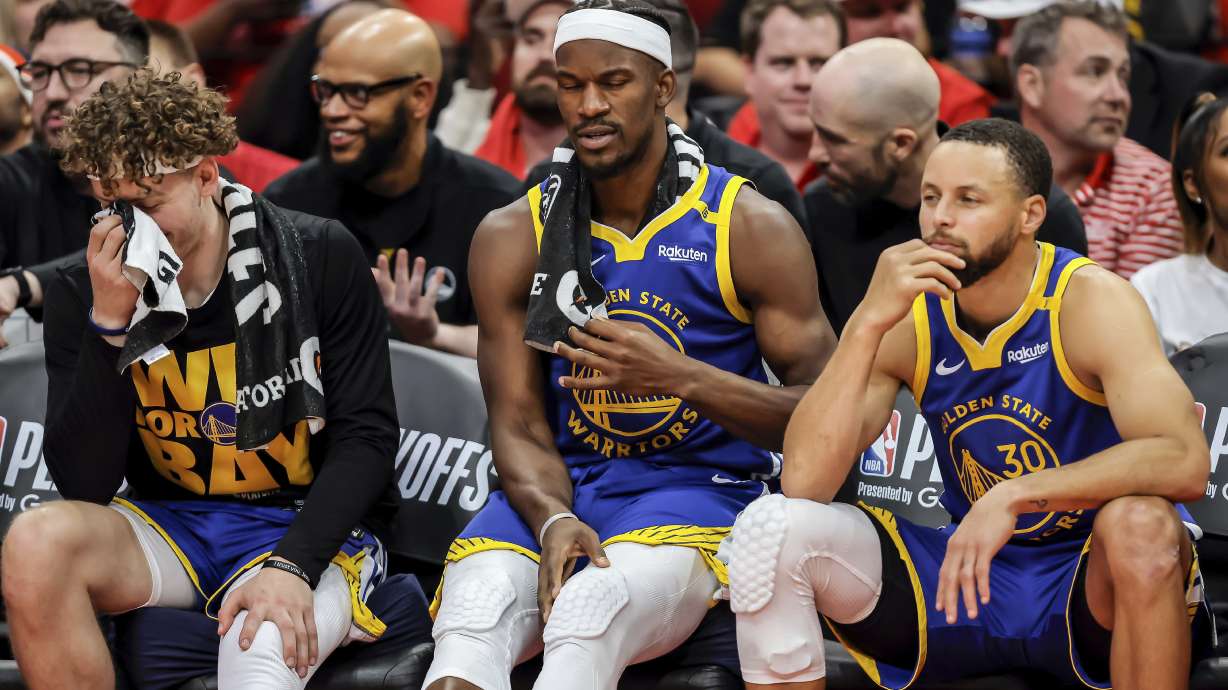 Brandin Podziemksi (2), Jimmy Butler (10) and Stephen Curry (30) react on the bench in the final seconds of the second half as the Golden State Warriors played the Houston Rockets in Game 5 of the First Round of the NBA Playoffs at Toyota Center in Houston, Texas on Wednesday, April 30, 2025.