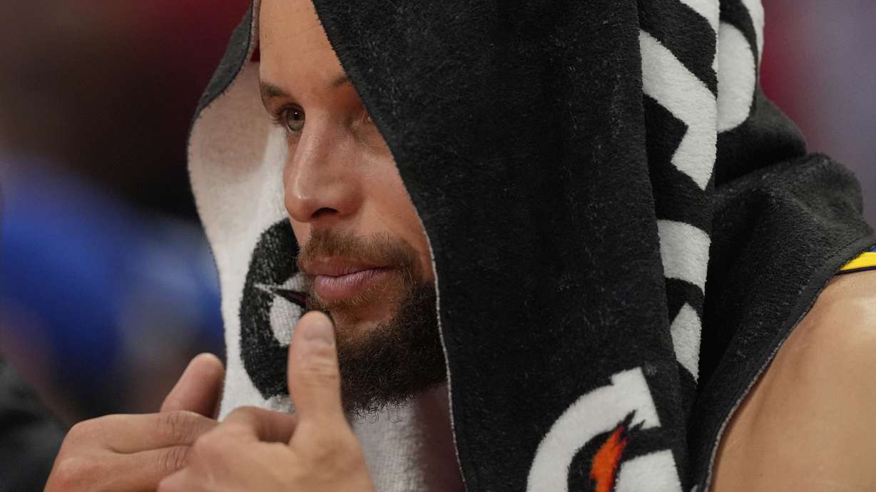 Golden State Warriors guard Stephen Curry watches from the bench during the second half of Game 5 of an NBA basketball first-round playoff series against the Houston Rockets, Wednesday, April 30, 2025, in Houston.