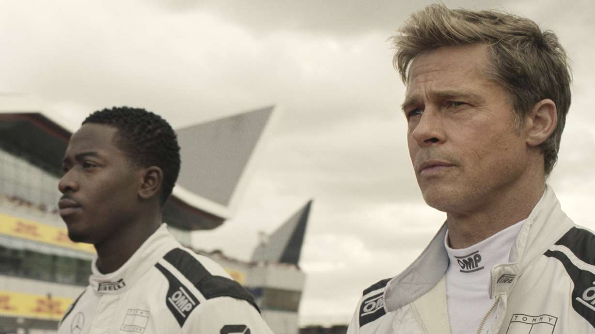 This image released by Warner Bros. Pictures shows Damson Idris, left, and Brad Pitt in a scene from "F1."