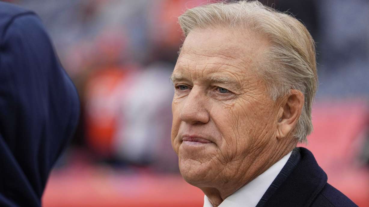 FILE - John Elway, Denver Broncos president of football operations, looks on before an NFL football game against the Washington Football Team, Oct. 31, 2021, in Denver.