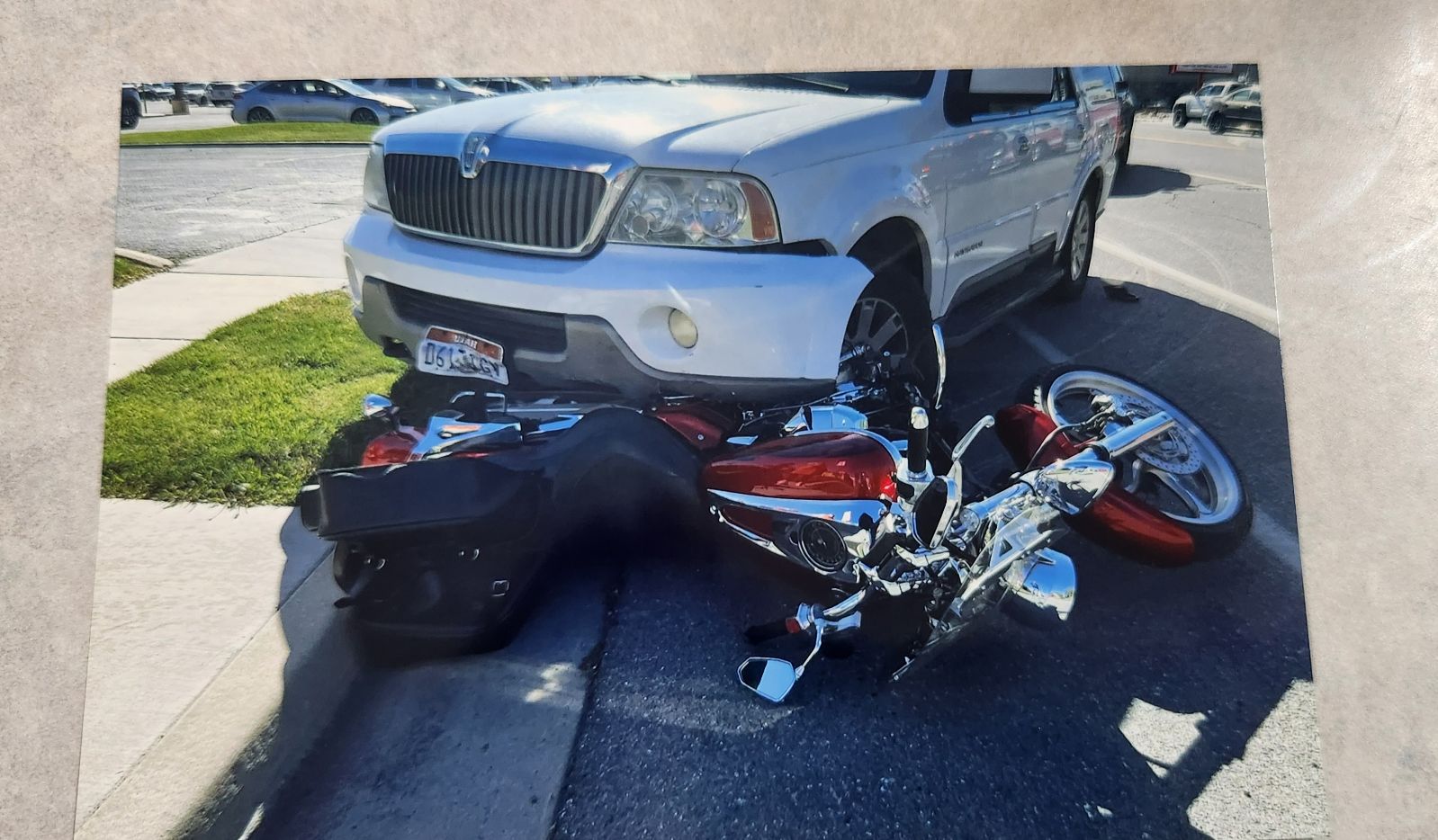 Rachel Trim's motorcycle was caught under the bumper of the vehicle that hit it, dragging it across the road. Trim was hit by a driver while riding her motorcycle in May 2024. - Rachel Trim