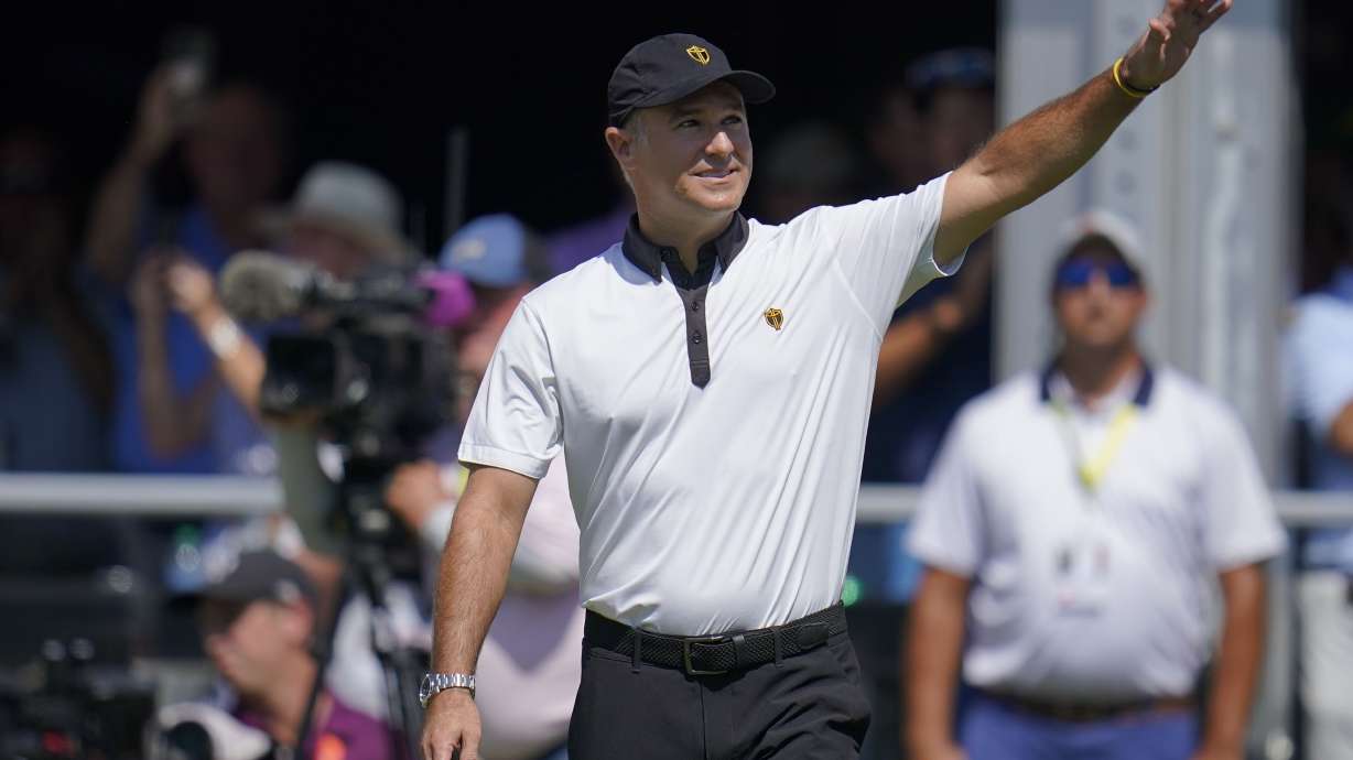FILE - International team captain Trevor Immelman waves toward the gallery before a foursomes match at the Presidents Cup golf tournament at the Quail Hollow Club, Sept. 22, 2022, in Charlotte, N.C.