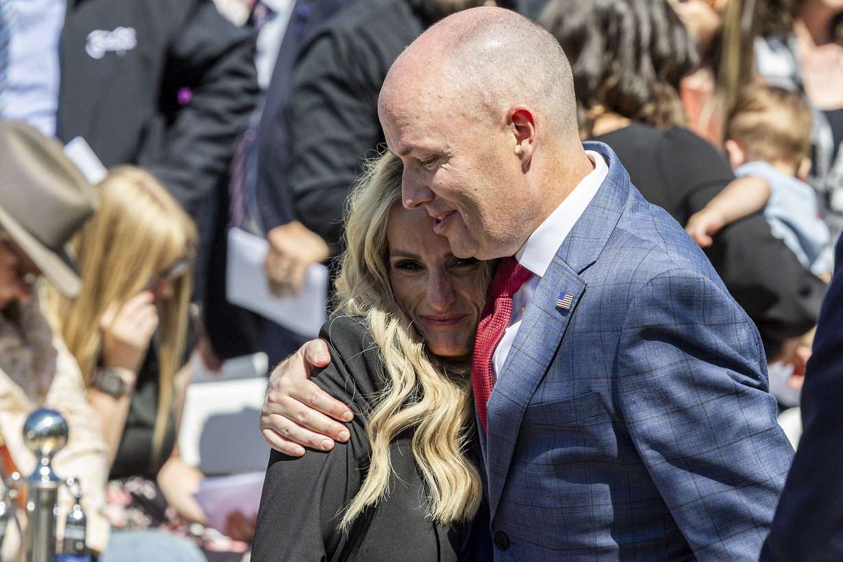Utah Gov. Spencer Cox hugs Kinda Hooser, wife of the late Santaquin Police Sgt. Billy D. Hooser, after the annual Utah Police Memorial Service held at the Utah Law Enforcement Memorial outside the Capitol in Salt Lake City on Thursday.
