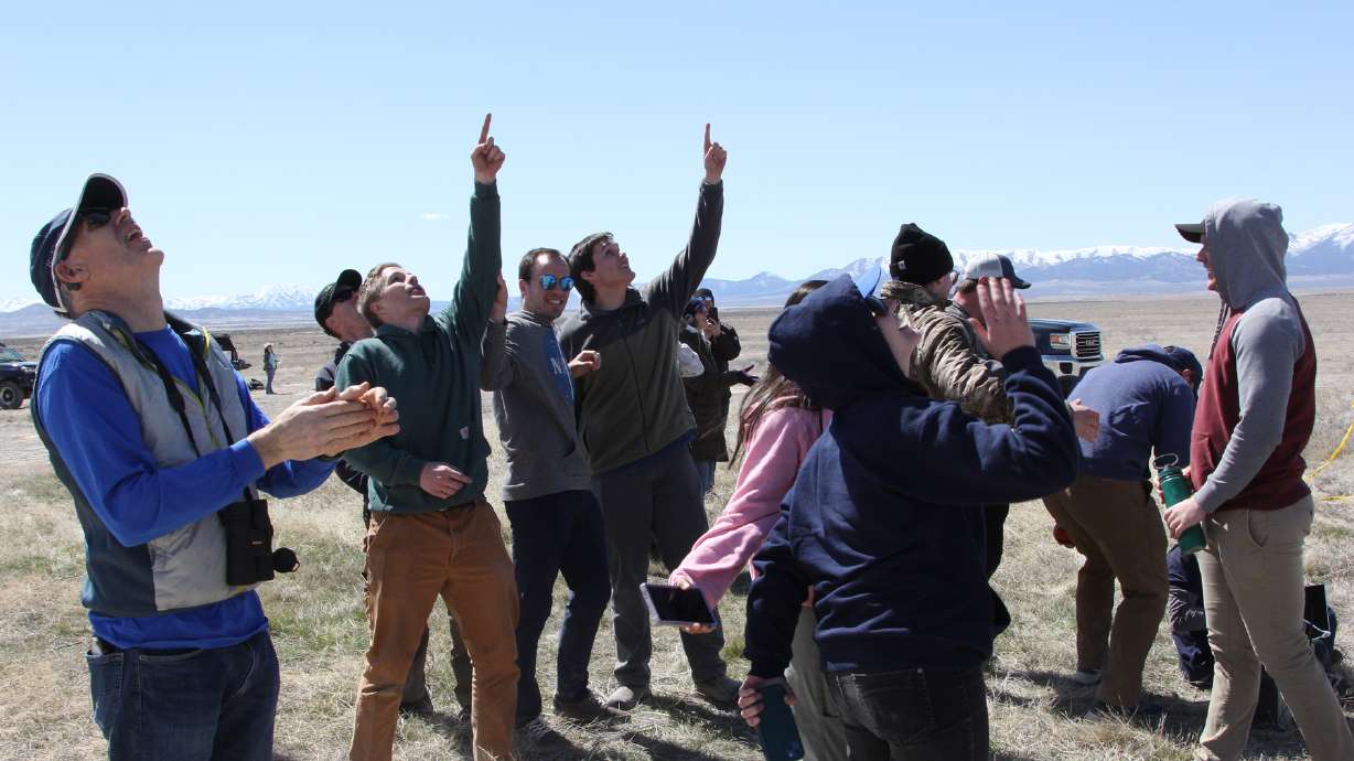 BYU Rocketry Club members cheer and watch a hybrid motor rocket fly through the air after a successful test launch on April 5 in Tooele.