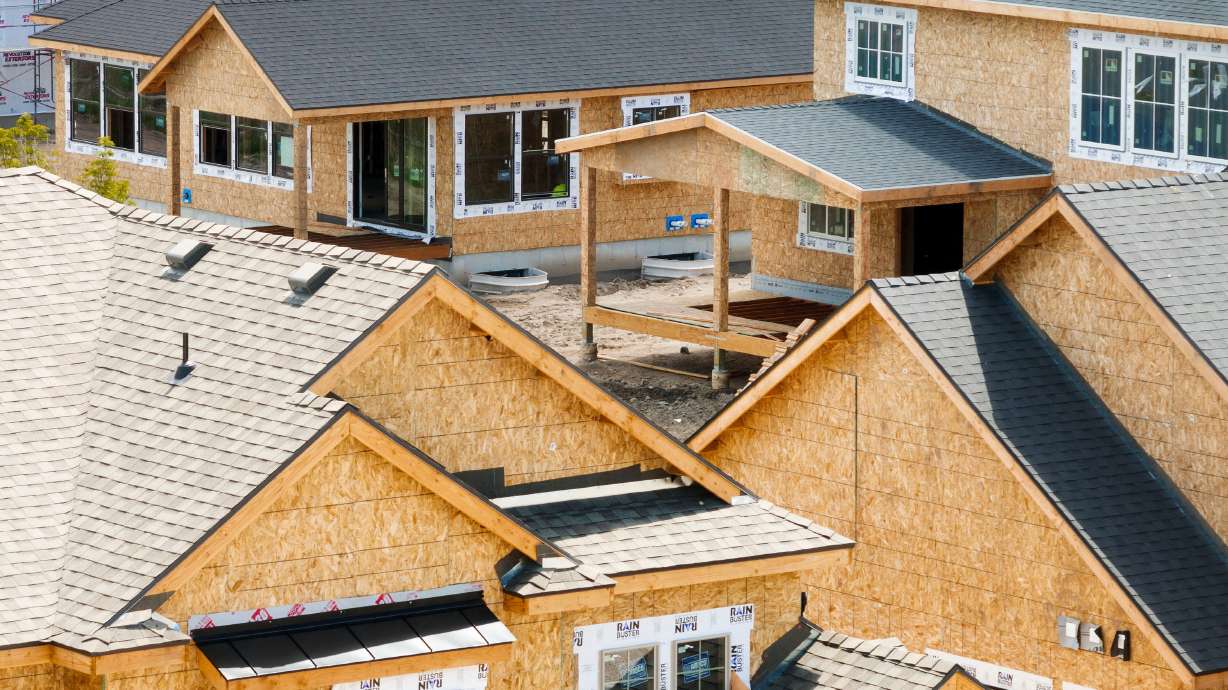 Homes under construction are pictured in Draper on Thursday. Builders are trying to lure buyers by buying down mortgage rates, cutting prices, upgrading features and even giving away vouchers worth $5,000, The Wall Street Journal reported.