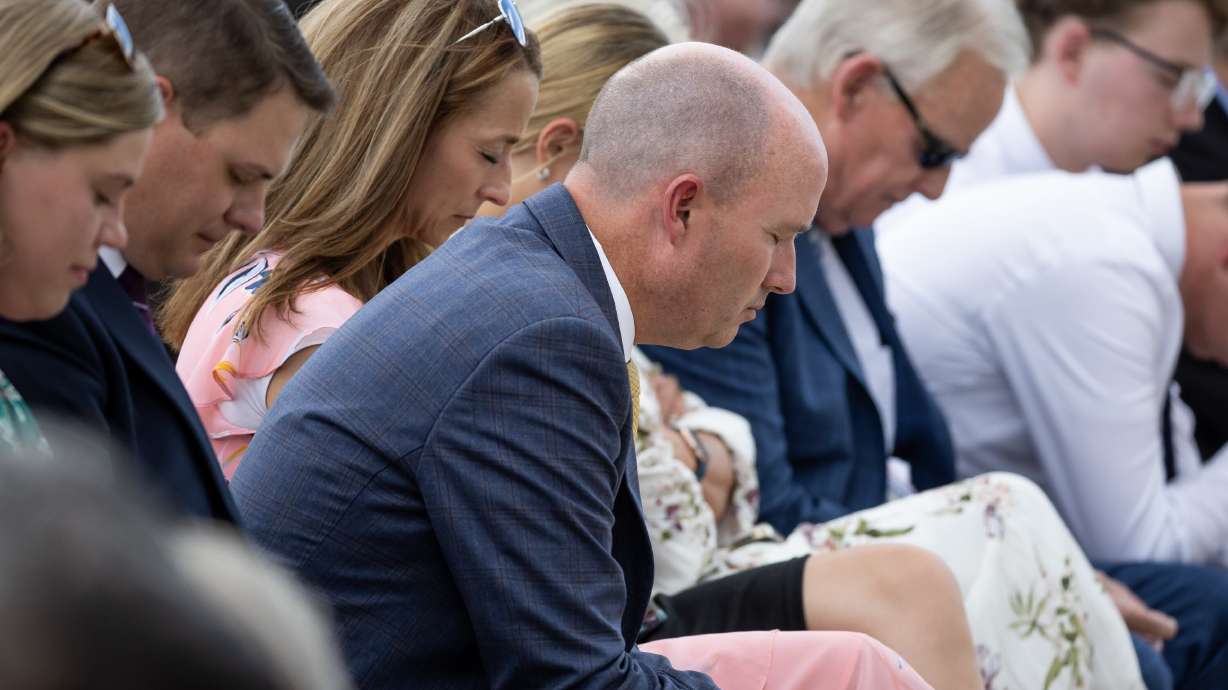 Gov. Spencer Cox and his wife, Abby, bow their heads as President Russell M. Nelson of The Church of Jesus Christ of Latter-day Saints gives the dedicatory prayer at the groundbreaking ceremony for the Ephraim Utah Temple on Aug. 27, 2022.