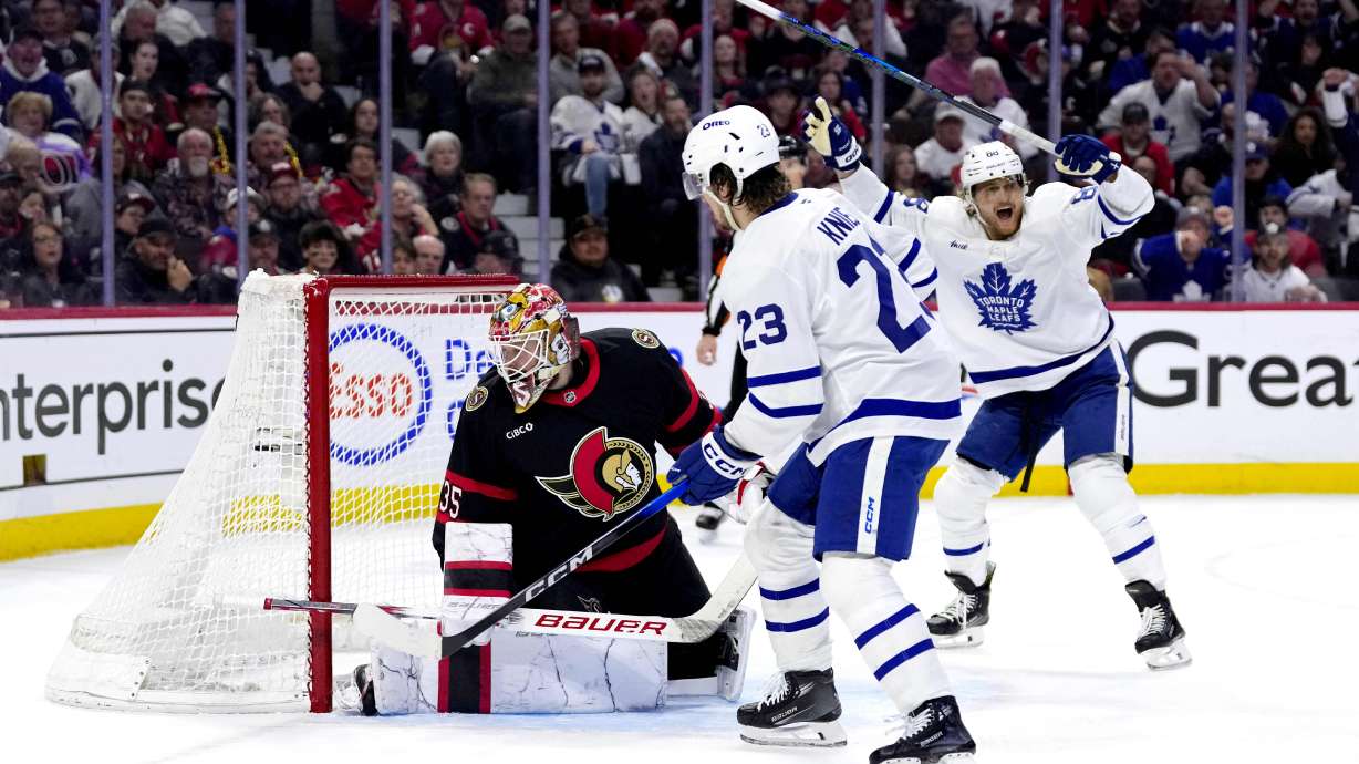 Toronto Maple Leafs' William Nylander, right, and Matthew Knies (23) celebrate as Auston Matthews (not shown) scores against Ottawa Senators goaltender Linus Ullmark (35) during the first period of Game 6 of a first-round NHL hockey playoff series in Ottawa, Ontario, Thursday, May 1, 2025.