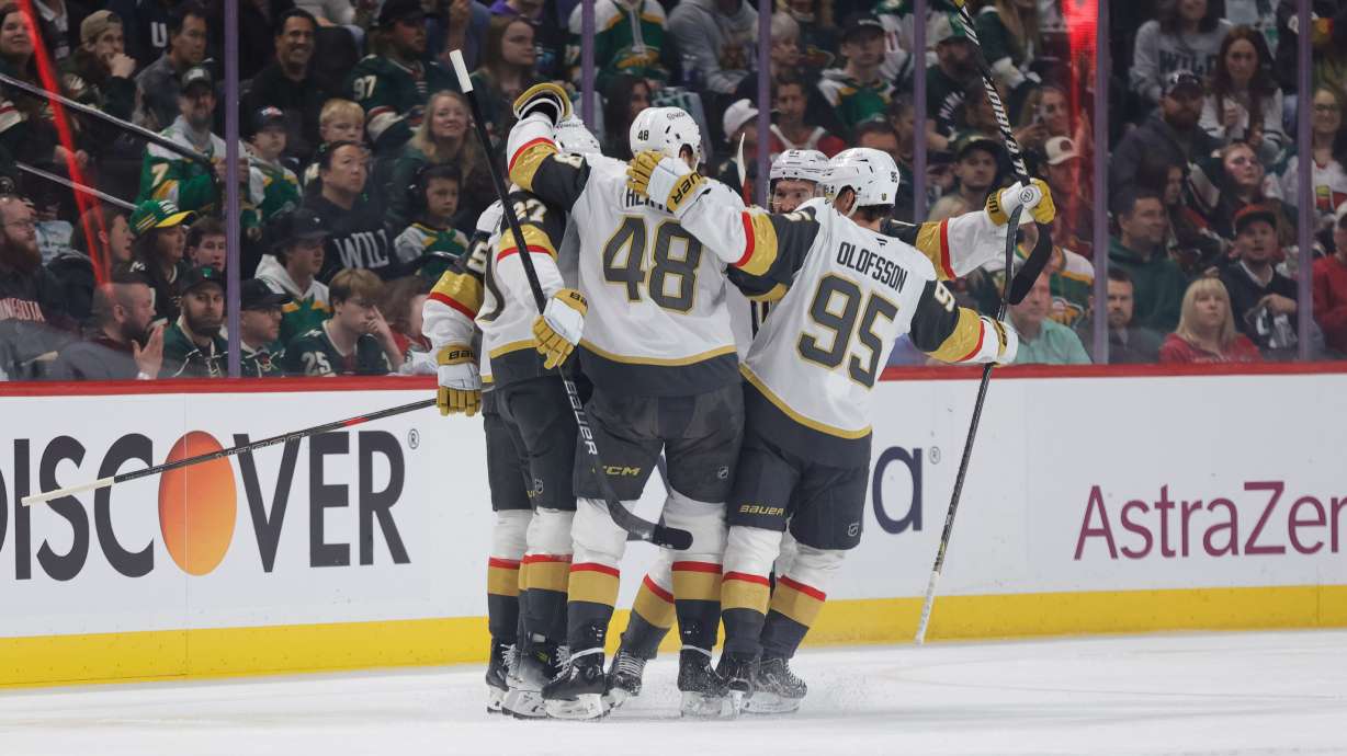 Vegas Golden Knights defenseman Shea Theodore (27) celebrates with teammates after scoring a power play goal during the first period of Game 6 of a first-round NHL hockey playoff series against the Minnesota Wild, Thursday, May 1, 2025, in St. Paul, Minn.