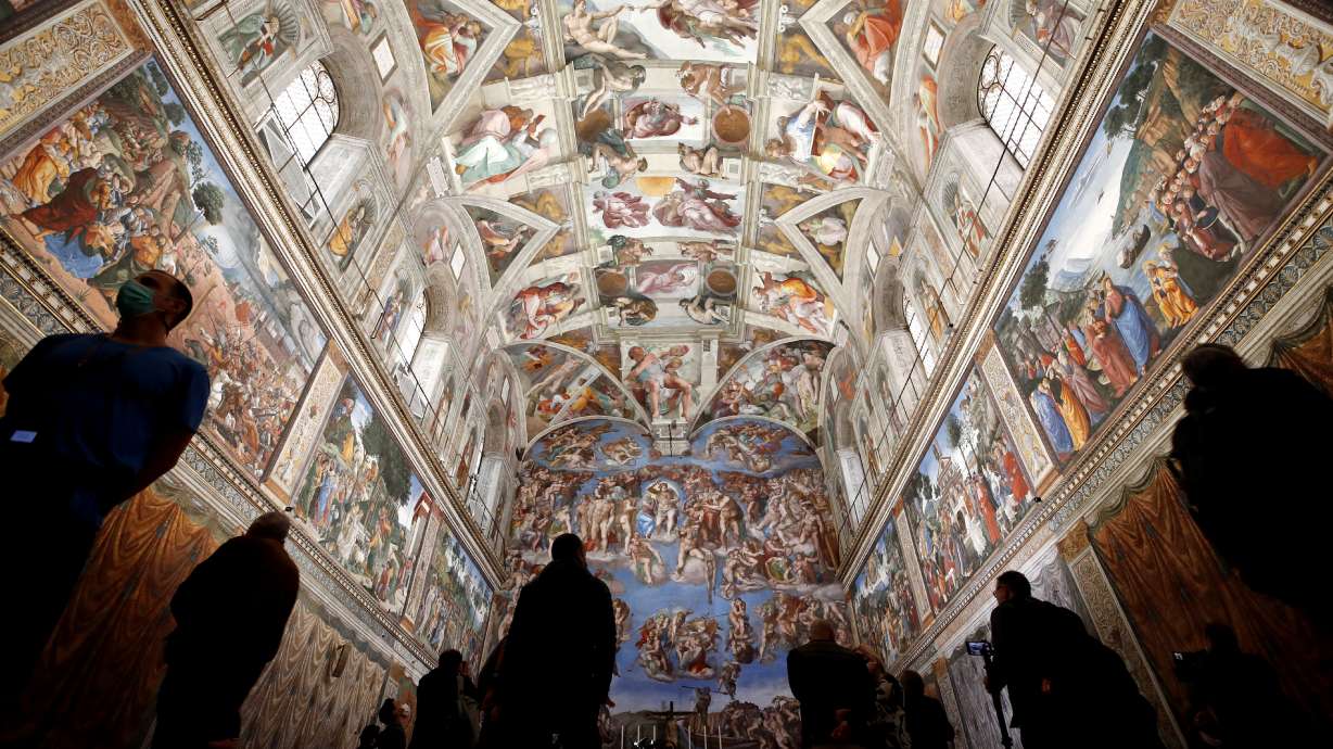 Visitors admire the Sistine Chapel inside the Vatican Museums on the occasion of the museum's reopening, in Rome, May 3, 2021. A chimney was installed on the roof for the papal election following the death of Pope Francis.