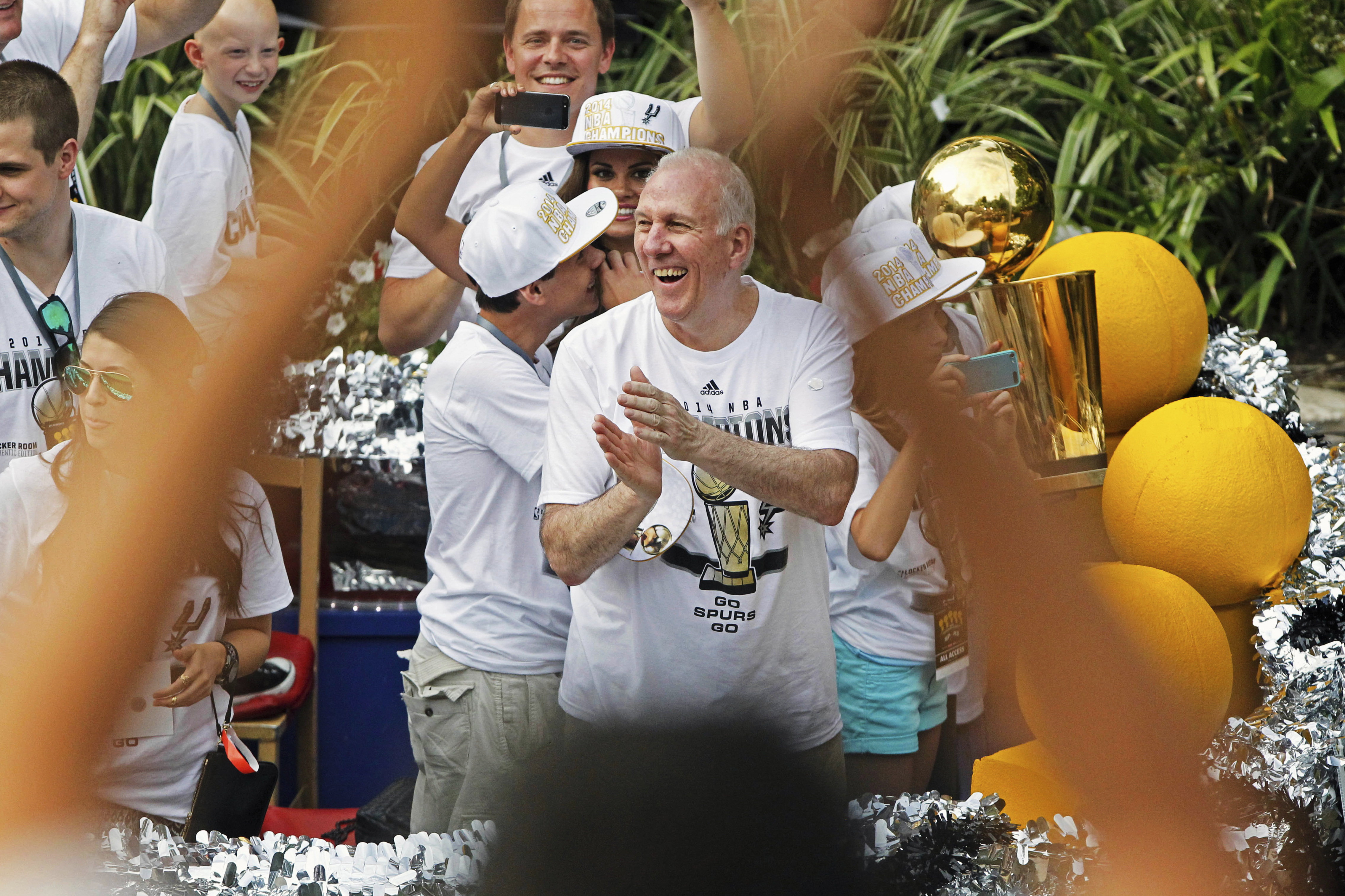 FILE - San Antonio Spurs head coach Gregg Popovich, center, claps during the basketball team's parade and celebration for their fifth NBA Championship, Wednesday, June 18, 2014, in San Antonio.
