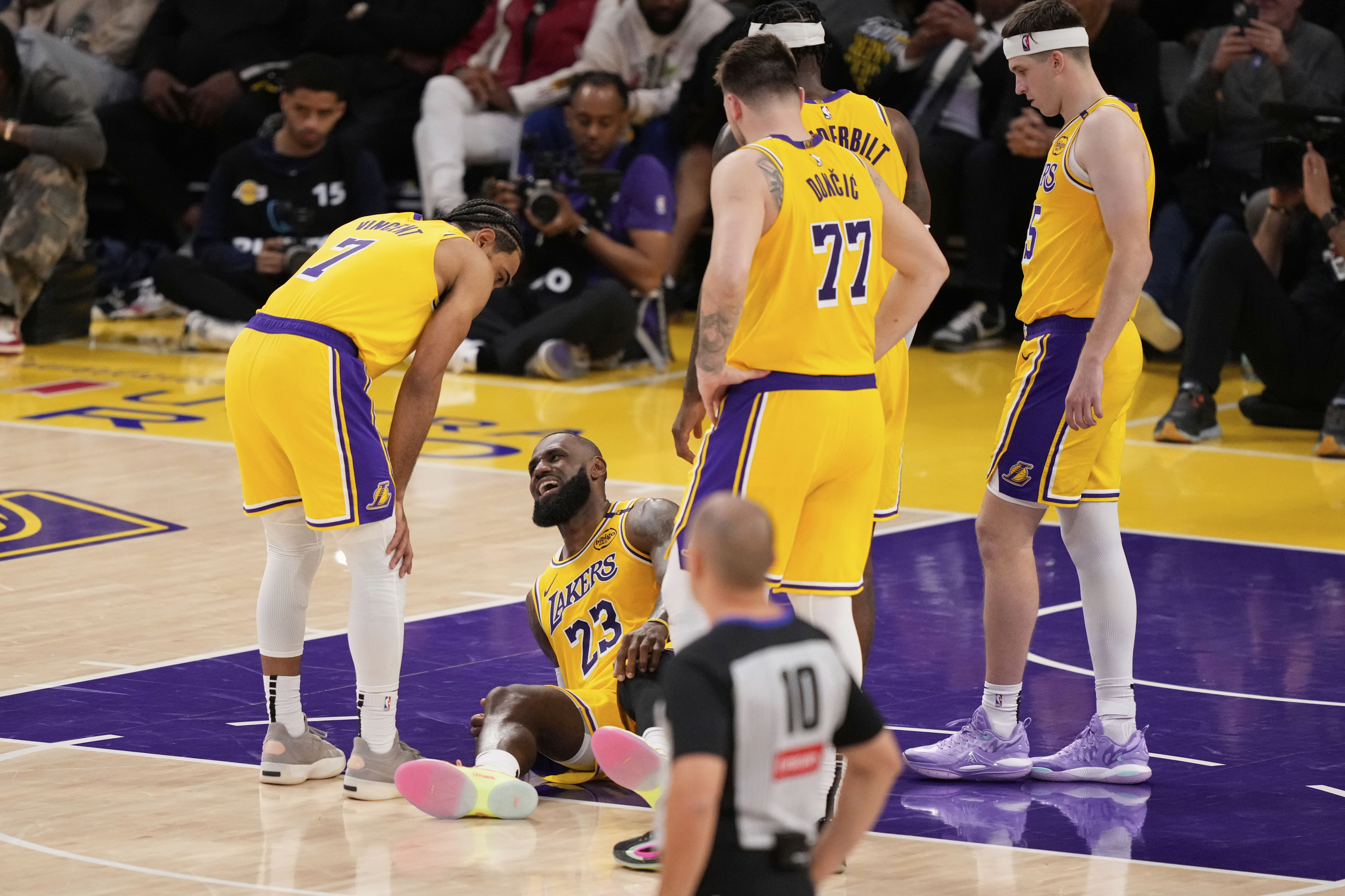 Los Angeles Lakers forward LeBron James lays on the floor after injuring his knee during the second half in Game 5 of an NBA basketball first-round playoff series against the Minnesota Timberwolves, Wednesday, April 30, 2025, in Los Angeles. 