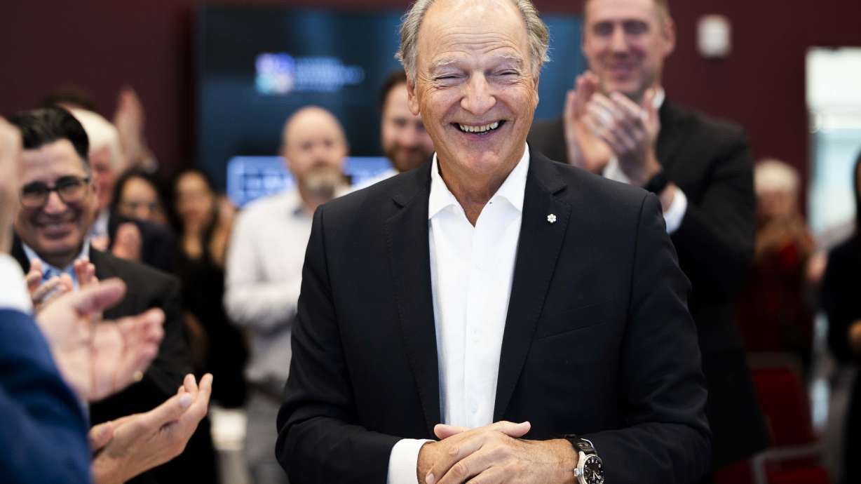Pierre Lassonde smiles and thanks the crowd during a standing ovation to him at a ceremony celebrating a donation by the Lassonde family of $25 million to the Lassonde Entrepreneur Institute at the University of Utah in Salt Lake City on Friday.