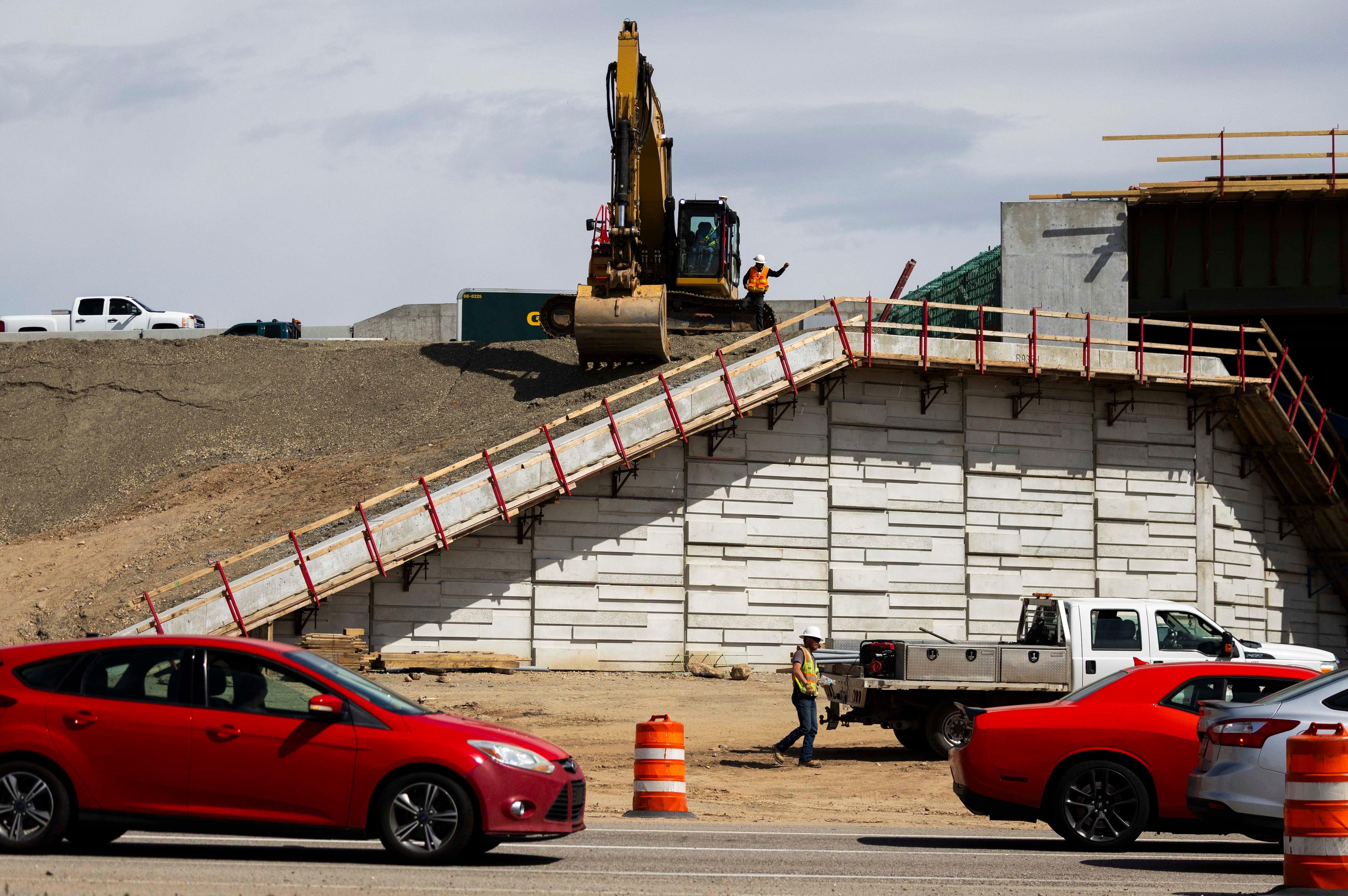 Construction workers work on an overpass in Roy on April 15. The Utah Department of Transportation has announced 152 new construction projects worth $1.68 billion, with another 145 already in progress.