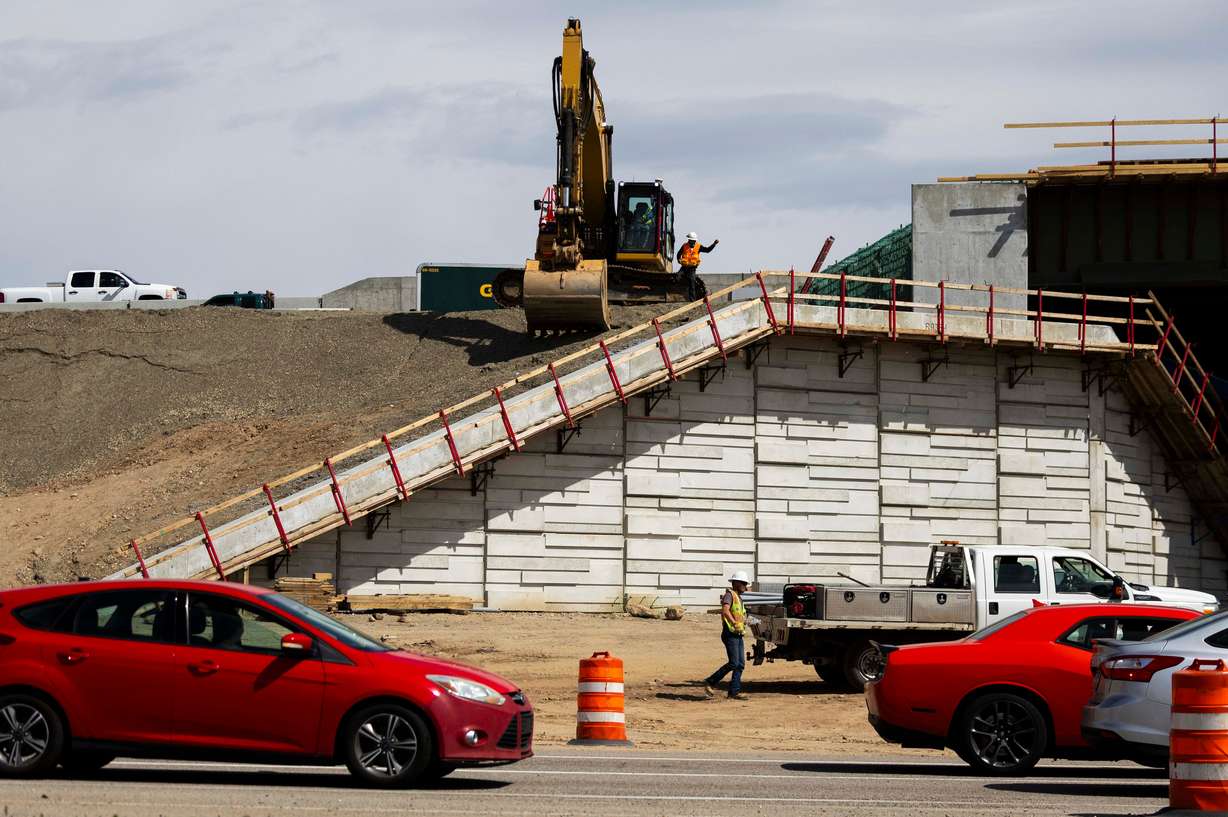 Construction workers work on an overpass in Roy on April 15. The Utah Department of Transportation has announced 152 new construction projects worth $1.68 billion, with another 145 already in progress.