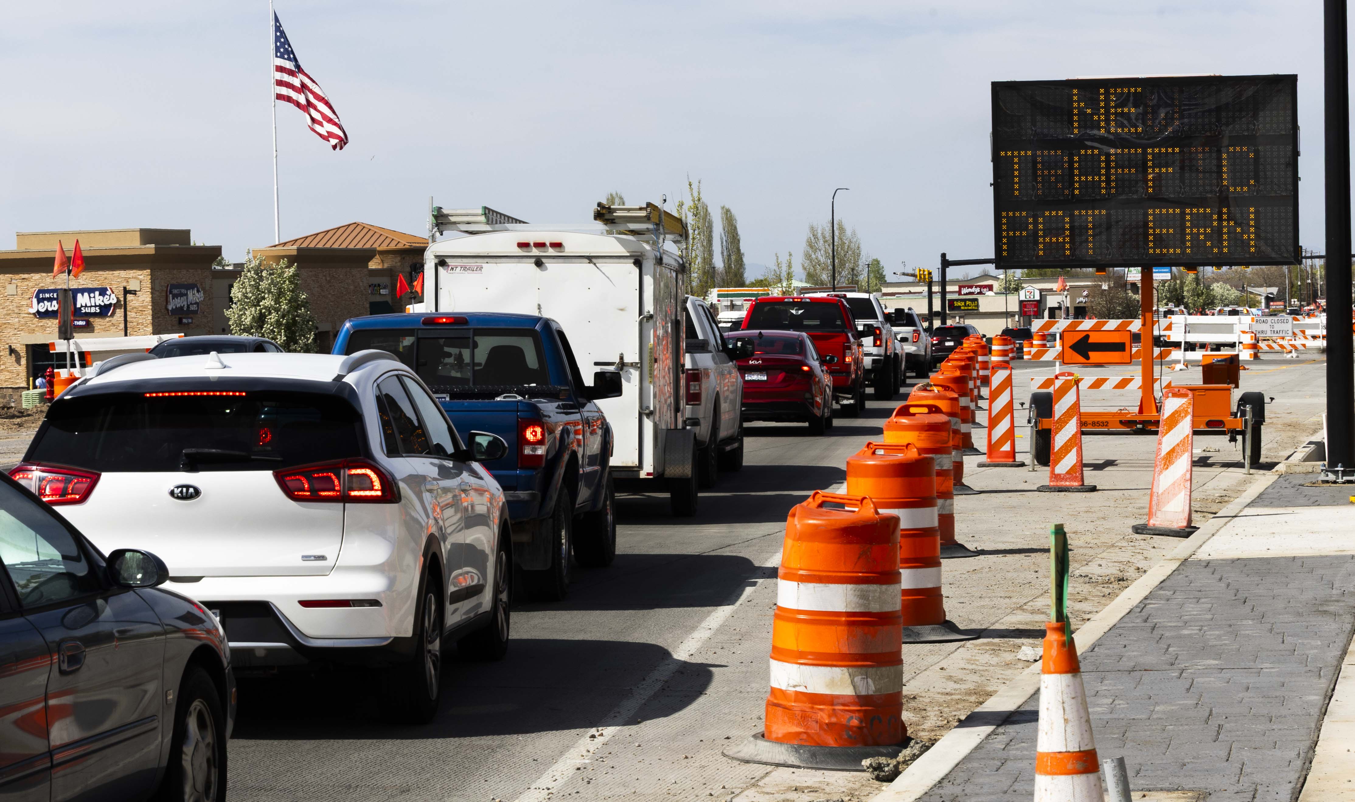 Cars pass through a construction zone connected to a project to widen 1800 North in Sunset on April 15. The Utah Department of Transportation has announced 152 new construction projects worth $1.68 billion, with another 145 already in progress.