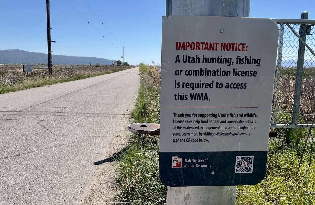 A sign warning visitors about a license requirement at Farmington Bay Waterfowl Management Area in Farmington is pictured on Friday. The law goes into effect next week.
