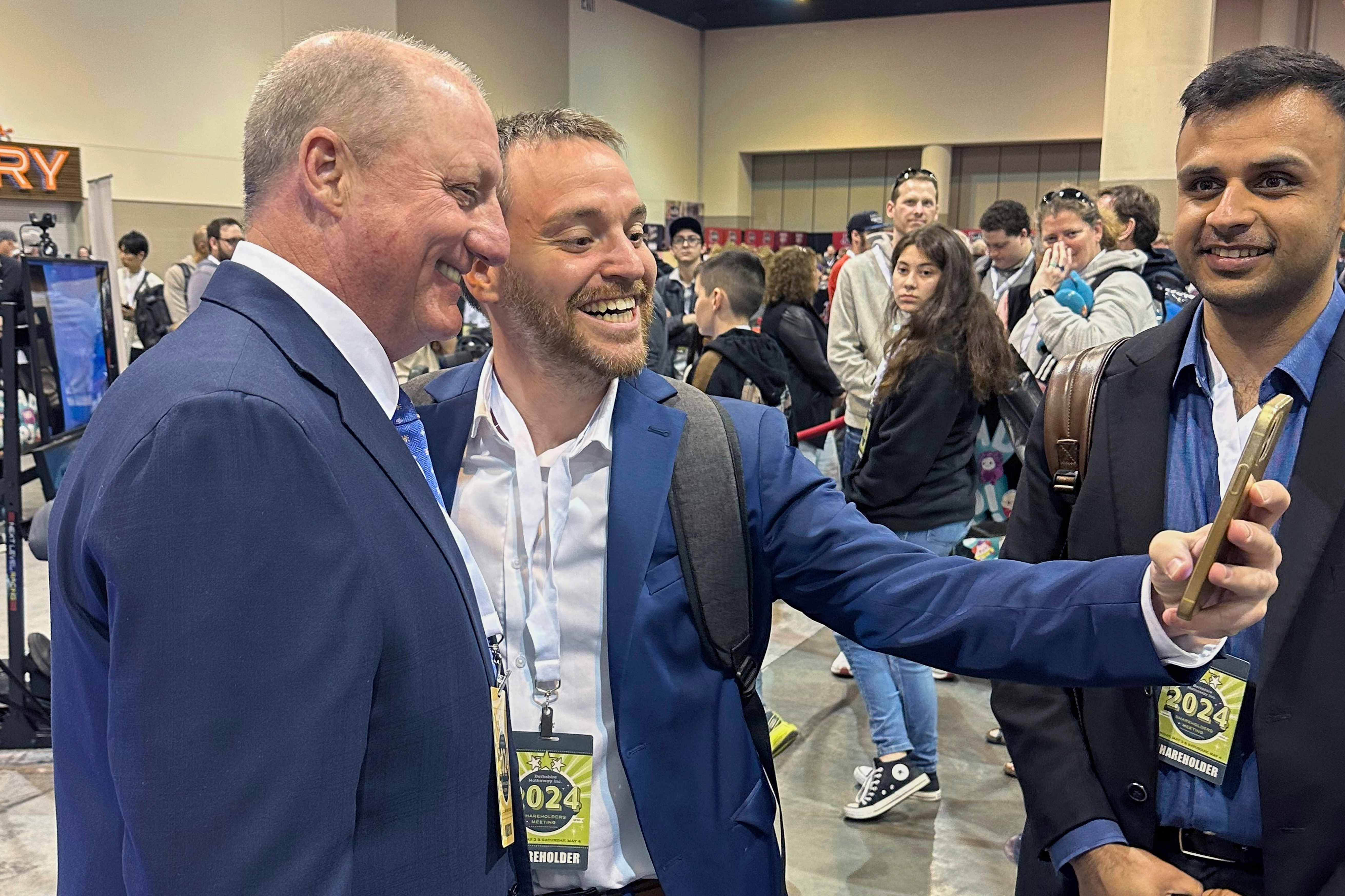 Berkshire Hathaway shareholders line up to take selfies with Greg Abel, May 3, 2024, in Omaha, Neb. In announcing his retirement Saturday, Berkshire Chairman Warren Buffett said he will recommend to Berkshire Hathaway's board on Sunday that Abel should become CEO at the end of the year.