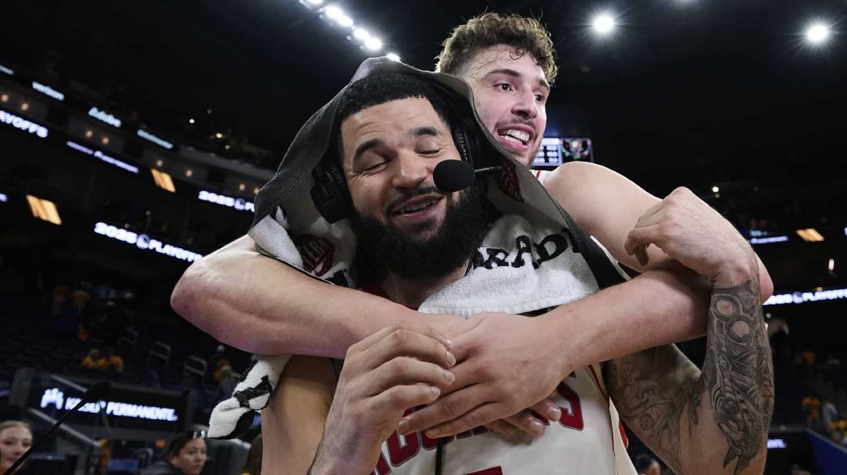 Houston Rockets guard Fred VanVleet (5) is hugged by center Alperen Sengun after the team's victory over the Golden State Warriors in Game 6 of an NBA basketball first-round playoff series Friday, May 2, 2025, in San Francisco.