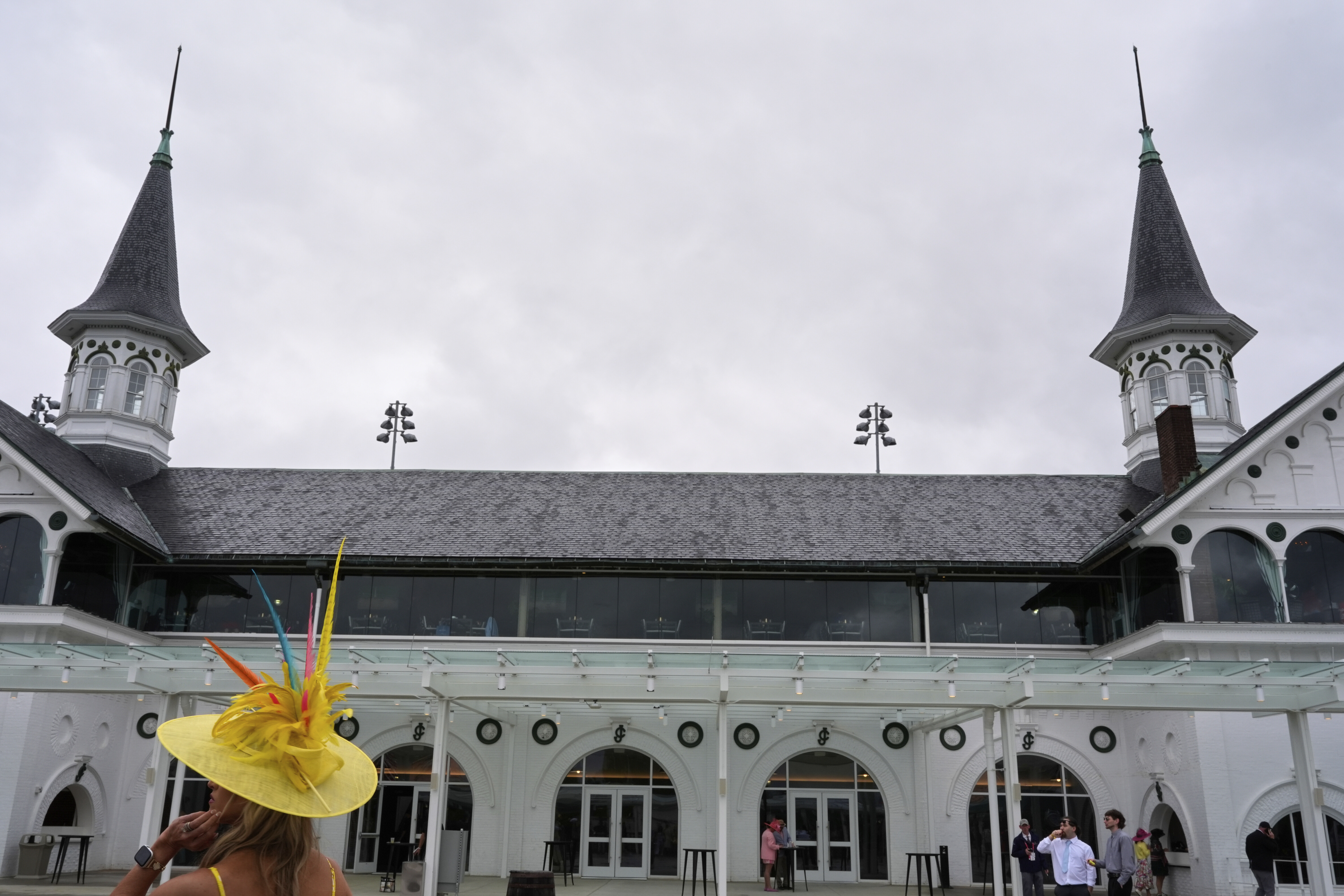 Race fans walk though the grounds at Churchill Downs before the 151st running of the Kentucky Derby horse race Saturday, May 3, 2025, in Louisville, Ky.