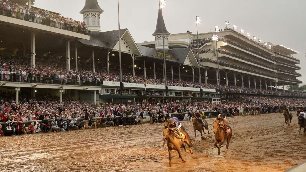 Sovereignty, left, ridden by Junior Alvarado, crosses the finish line to win the 151st running of the Kentucky Derby horse race at Churchill Downs Saturday in Louisville, Ky.