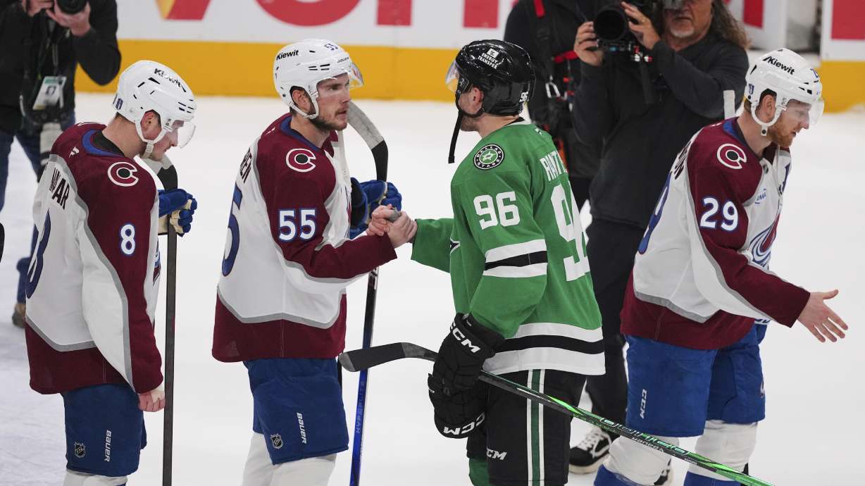 Colorado Avalanche's Cale Makar (8), Ryan Lindgren (55) Dallas Stars' Mikko Rantanen (96) and Nathan MacKinnon (29) exchange handshakes after the Stars 4-2 win in Game 7 of a first-round NHL hockey playoff series Saturday, May 3, 2025, in Dallas.