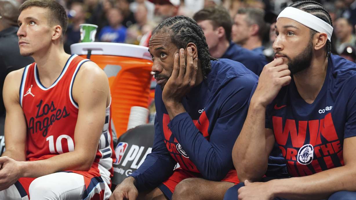From left to right, Los Angeles Clippers guard Bogdan Bogdanovic, forward Kawhi Leonard and guard Ben Simmons look on as time runs out in Game 7 of an NBA basketball first-round playoff series against the Denver Nuggets,Saturday, May 3, 2025, in Denver.