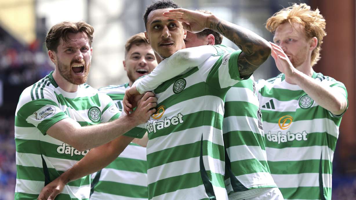 Celtic's Adam Idah, center, celebrates scoring their side's first goal of the game with teammates during the Scottish Premiership soccer match between Rangers and Celtic at Ibrox Stadium, Glasgow, Scotland, Sunday, May 4, 2025.