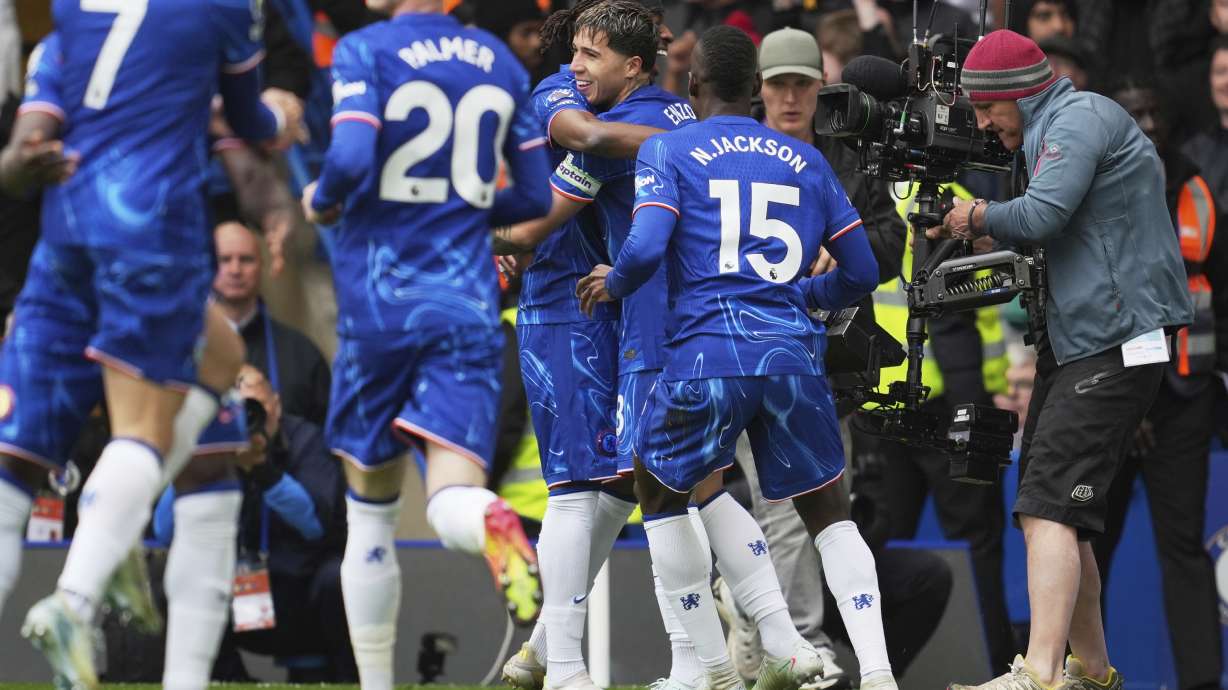 Chelsea's Enzo Fernandez, back center, is congratulated after scoring his side's opening goal during the English Premier League soccer match between Chelsea and Liverpool at Stamford Bridge stadium in London, Sunday, May 4, 2025.