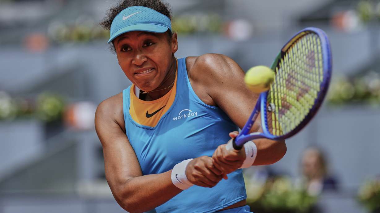 Naomi Osaka, of Japan, returns the ball against Lucia Bronzetti, of Italy, during the Madrid Open tennis tournament in Madrid, Spain, Tuesday, April 22, 2025.