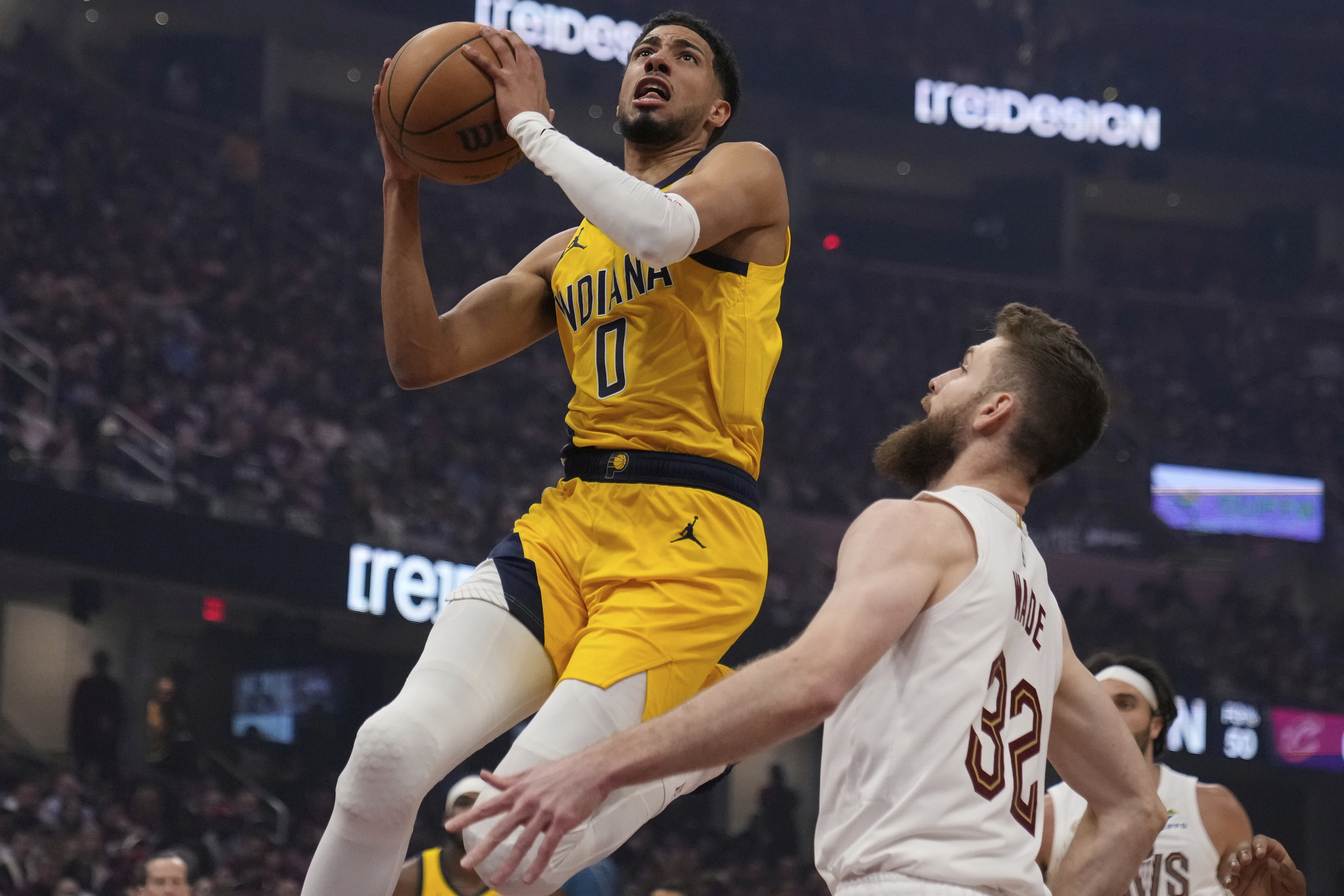 Indiana Pacers' Tyrese Haliburton (0) goes to the basket in front of Cleveland Cavaliers' Dean Wade (32) in the first half of Game 1 in the Eastern Conference semifinals of the NBA basketball playoffs Sunday, May 4, 2025, in Cleveland. 