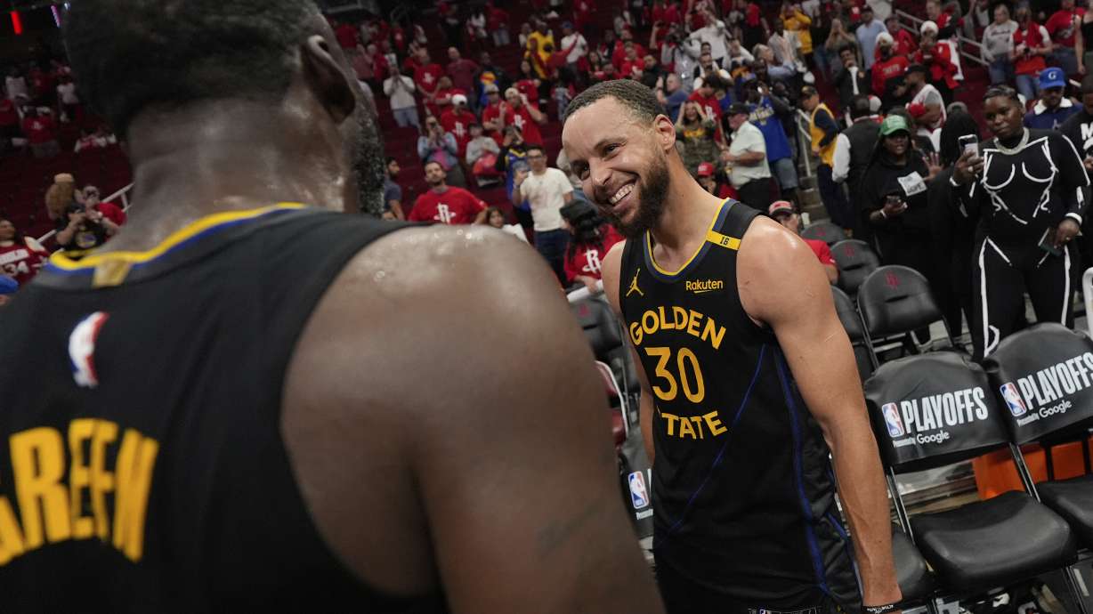 Golden State Warriors' Stephen Curry (30) and Draymond Green celebrate after Game 7 of an NBA basketball first-round playoff series against the Houston Rockets Sunday, May 4, 2025, in Houston.