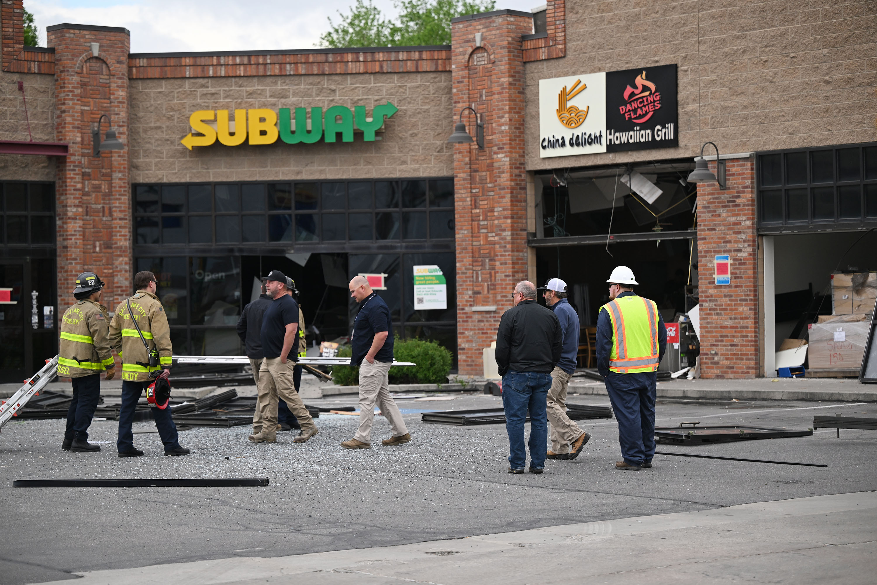 Officials investigate after an early morning explosion at the Extra Mile Chevron station near 1700 W. North Temple on Monday.