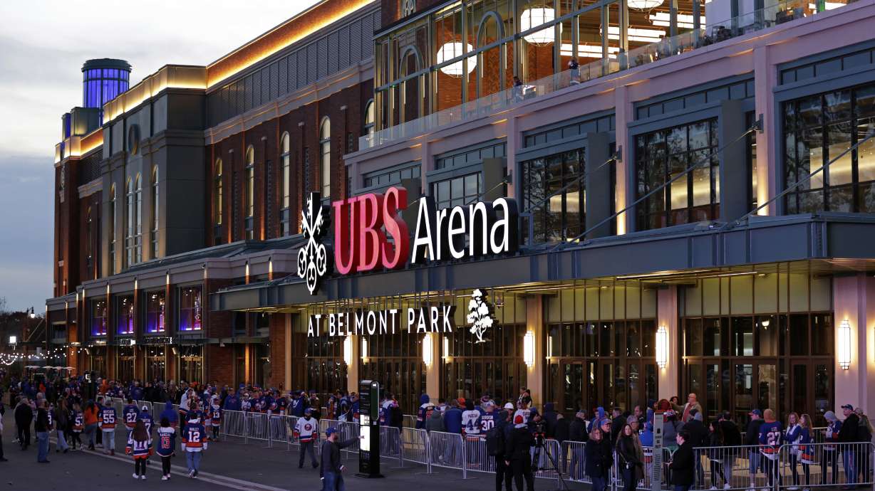 FILE - Fans wait to enter the new UBS Arena for the first New York Islanders NHL hockey game against the Calgary Flames, on Nov. 20, 2021, in Elmont, N.Y.