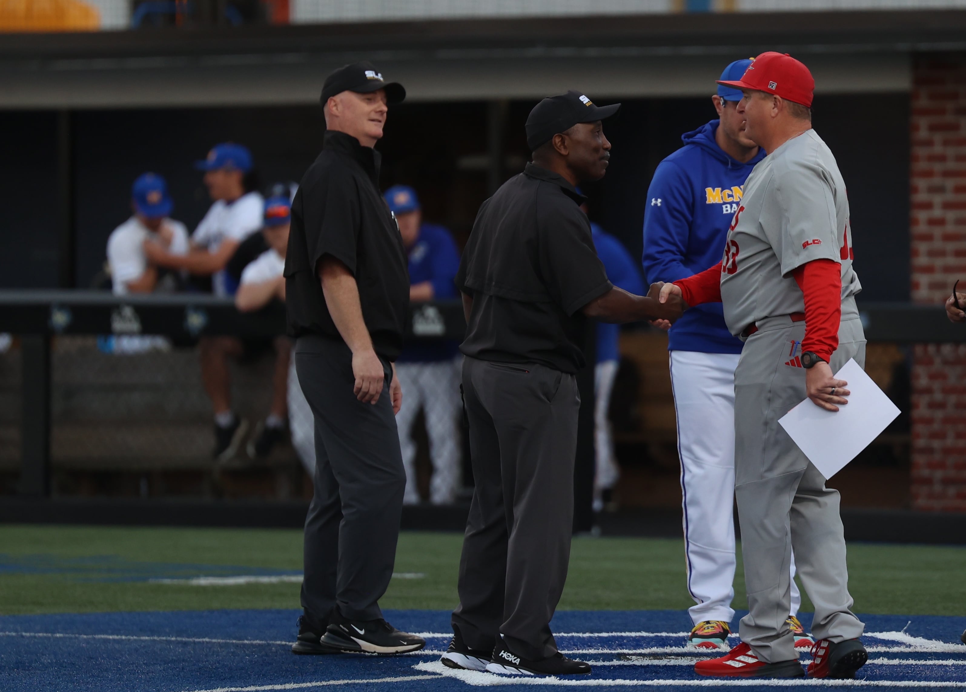 First-year Nicholls State baseball head coach Brent Haring shakes hands with the umpire crew prior to a game during the 2025 season.