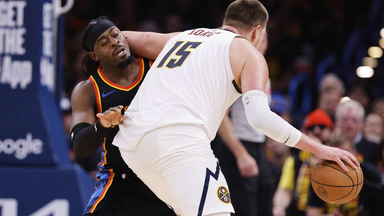 Oklahoma City Thunder guard Luguentz Dort (5) takes an elbow to the back of the head from Denver Nuggets' Nikola Jokic (15) in the second half of Game 1 of an NBA basketball second-round playoff series Monday, May 5, 2025, in Oklahoma City.