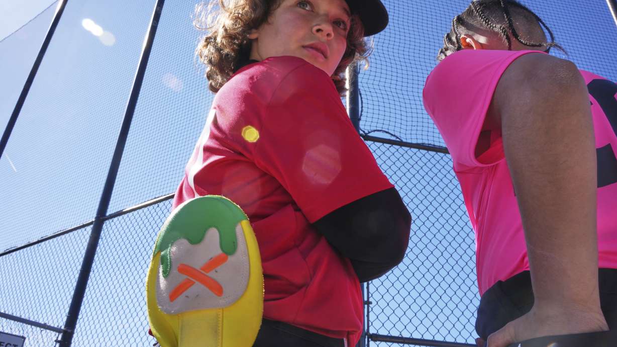 Youth ballplayer Grayson Cole, left, waits for his game to get underway with his Savannah Banana sliding mitt in his back pocket on April 27, 2025 in Monroeville, Pa.