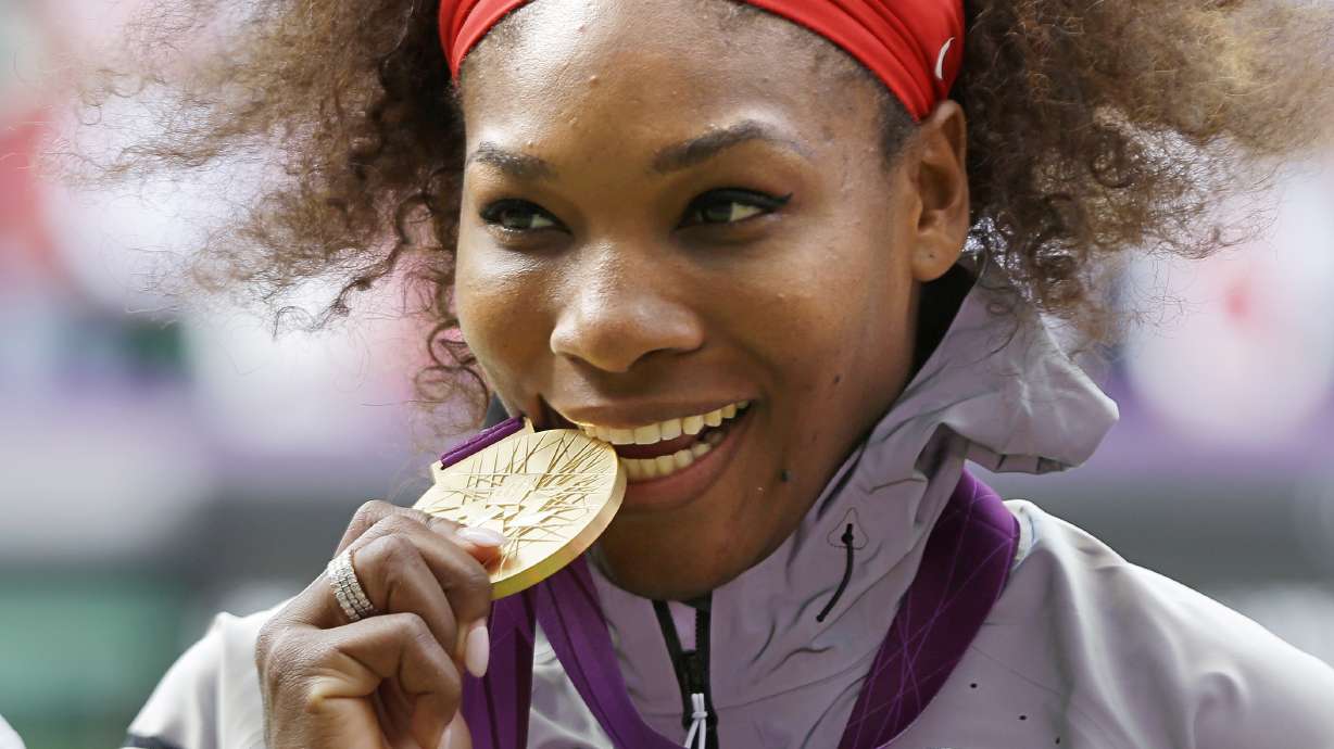 FILE - This Aug. 4, 2012 file photo shows Serena Williams posed with her 2012 Summer Olympics gold medal during the podium ceremony of the women's singles final match at the All England Lawn Tennis Club at Wimbledon, in London.