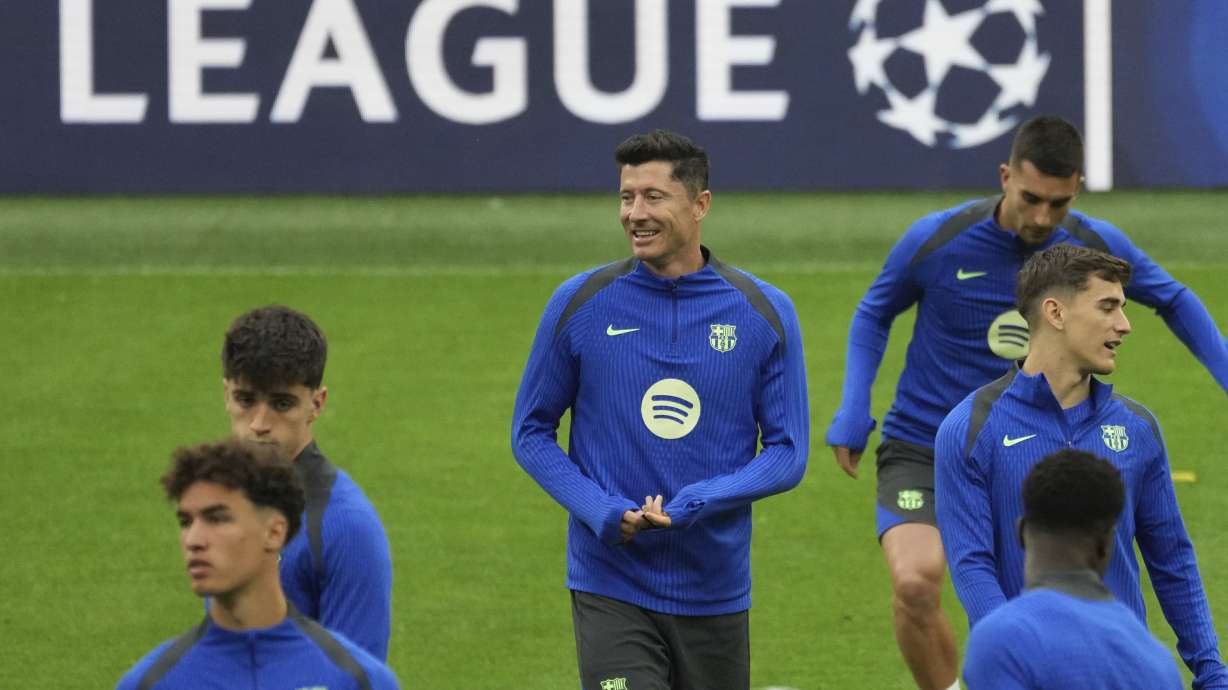 Barcelona's Robert Lewandowski, centre, smiles during a training at the San Siro stadium in Milan, Italy, Monday, May 5, 2025, ahead of the Champions League semifinals second leg soccer match between Inter Milan and Barcelona on Tuesday.